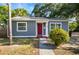 Charming home featuring gray siding, a vibrant red front door, and well-manicured landscaping for a welcoming curb appeal at 601 Newton S Ave, St Petersburg, FL 33701