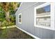 Charming home featuring wooden siding and white trim around the windows and roofline at 601 Newton S Ave, St Petersburg, FL 33701