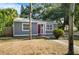 Charming single-story home with a red front door and a well-maintained lawn at 601 Newton S Ave, St Petersburg, FL 33701