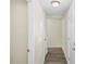 Hallway featuring neutral paint, wood-look floors, and white doors at 601 Newton S Ave, St Petersburg, FL 33701