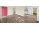 Open-concept living room with wood-look floors flowing into the kitchen area at 601 Newton S Ave, St Petersburg, FL 33701