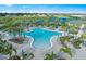 Expansive community pool area featuring palm trees, lounge chairs, and a vibrant atmosphere at 6017 Silver Grass Ct, Nokomis, FL 34275