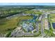 Aerial view of community featuring amenities, swimming pool, tennis courts, and surrounding homes at 6017 Silver Grass Ct, Nokomis, FL 34275