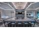 Upscale bar area with granite countertops, ample seating, display shelving and adjacent seating area at 6017 Silver Grass Ct, Nokomis, FL 34275