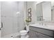 Modern bathroom featuring a glass-enclosed shower, stylish fixtures, and a gray vanity at 6017 Silver Grass Ct, Nokomis, FL 34275