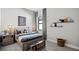 Cozy bedroom with modern decor, a stylish bench, and a unique wall art display at 6017 Silver Grass Ct, Nokomis, FL 34275