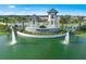 Community entrance with water feature, lush landscaping, and elegant signage at 6017 Silver Grass Ct, Nokomis, FL 34275