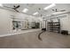 Modern exercise room with mirrors, hanging suspension trainers, and weight racks for a complete workout at 6017 Silver Grass Ct, Nokomis, FL 34275