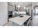 Modern kitchen with a large island, stainless steel appliances, pendant lighting, and stylish countertops at 6017 Silver Grass Ct, Nokomis, FL 34275