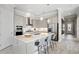 Modern kitchen with a large island, stainless steel appliances, pendant lighting, and stylish countertops at 6017 Silver Grass Ct, Nokomis, FL 34275