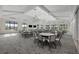 Bright meeting room with tables and chairs under high ceilings and decorative chandelier lighting at 6017 Silver Grass Ct, Nokomis, FL 34275