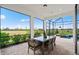 Relaxing outdoor patio with a seating area, overlooking a lush green landscape and spa at 6017 Silver Grass Ct, Nokomis, FL 34275