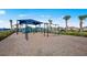 Community playground featuring swings and a play structure with palm trees surrounding the area at 6017 Silver Grass Ct, Nokomis, FL 34275
