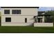 A modern two-story home with a neutral color scheme, large windows, and a covered outdoor space at 602 & 604 Channel Dr, Tampa, FL 33606