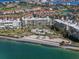 An elevated view of beachfront condos with a pool, beach, and lush landscaping near the water at 6021 Bahia Del Mar Cir # 238, St Petersburg, FL 33715