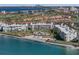 An elevated view of beachfront condos with a pool, beach, and lush landscaping near the water at 6021 Bahia Del Mar Cir # 238, St Petersburg, FL 33715