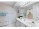 Bright bathroom with double sinks, a large mirror, and ample counter space for convenience at 6021 Bahia Del Mar Cir # 238, St Petersburg, FL 33715