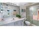 Bright bathroom features a glass-enclosed shower, white vanity, and a large mirror, creating a clean and modern look at 6021 Bahia Del Mar Cir # 238, St Petersburg, FL 33715