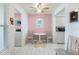 Cozy breakfast nook with white tile flooring, a round table, and pink accent wall at 6021 Bahia Del Mar Cir # 238, St Petersburg, FL 33715
