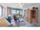 Comfortable living room with water views from the balcony, featuring a ceiling fan, and cozy seating arrangements at 6021 Bahia Del Mar Cir # 238, St Petersburg, FL 33715