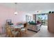 Inviting living room with pink walls and a balcony with water views and comfortable seating at 6021 Bahia Del Mar Cir # 238, St Petersburg, FL 33715