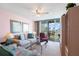Bright living room features comfortable seating, a ceiling fan, and a sliding glass door leading to a scenic balcony view at 6021 Bahia Del Mar Cir # 238, St Petersburg, FL 33715