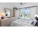 Bright bedroom with water views and balcony access features a comfortable bed and stylish decor at 6021 Bahia Del Mar Cir # 238, St Petersburg, FL 33715