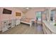 This bedroom features wood floors, a ceiling fan, and a pink color scheme at 6107 Heroncrest Ct, Lithia, FL 33547