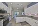 Modern kitchen with granite countertops, white cabinets, stainless steel appliances and view of the outdoor patio at 6107 Heroncrest Ct, Lithia, FL 33547