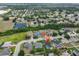 An aerial view showcases a tranquil neighborhood near a pond, surrounded by mature trees at 6332 35Th Avenue E Cir, Palmetto, FL 34221