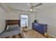 Small bedroom with wood floors, a purple dresser and a guitar at 6332 35Th Avenue E Cir, Palmetto, FL 34221