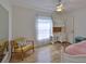 Bright bedroom with wood floors, natural light, and a charming desk area by the window at 6332 35Th Avenue E Cir, Palmetto, FL 34221