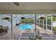Covered patio with dining table overlooking screened in pool and landscaped backyard at 6332 35Th Avenue E Cir, Palmetto, FL 34221