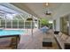 Inviting covered patio with comfortable seating overlooking the screened in pool and outdoor space at 6332 35Th Avenue E Cir, Palmetto, FL 34221