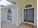 Inviting front entrance with an arched window, modern black door, and a 'welcome home' doormat at 6332 35Th Avenue E Cir, Palmetto, FL 34221