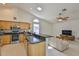 Open-concept kitchen featuring granite countertops, stainless steel appliances, and a breakfast bar at 6332 35Th Avenue E Cir, Palmetto, FL 34221
