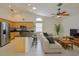 Open-concept living room and kitchen with stainless steel appliances and a breakfast bar with seating at 6332 35Th Avenue E Cir, Palmetto, FL 34221