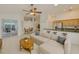 Bright and airy living room with a view to the outside sunroom, open to the kitchen and dining areas at 6332 35Th Avenue E Cir, Palmetto, FL 34221