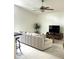Bright living room boasts a ceiling fan, neutral paint, tile flooring, and an entertainment center at 6332 35Th Avenue E Cir, Palmetto, FL 34221