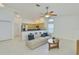Open-concept living room featuring tile floors, neutral décor, and kitchen breakfast bar at 6332 35Th Avenue E Cir, Palmetto, FL 34221