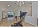 Open living area with pool views, built-in shelving, and an exercise bike at 6332 35Th Avenue E Cir, Palmetto, FL 34221