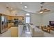 Open-concept living space featuring vaulted ceilings, a breakfast bar, and modern appliances at 6332 35Th Avenue E Cir, Palmetto, FL 34221