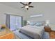 Cozy primary bedroom featuring a ceiling fan, large window, and a comfortable bed at 6332 35Th Avenue E Cir, Palmetto, FL 34221