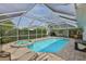 A screened-in pool with attached spa is surrounded by brick pavers and lush landscaping at 6332 35Th Avenue E Cir, Palmetto, FL 34221