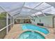 Screened-in pool and spa featuring a large deck area with outdoor seating and leafy garden at 6332 35Th Avenue E Cir, Palmetto, FL 34221