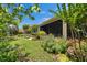 Beautiful screened in porch overlooks a tranquil backyard with colorful landscaping and mature trees at 6507 Maiden Sea Dr, Apollo Beach, FL 33572