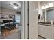 Bathroom featuring a vanity with granite countertop, white cabinets and view into a bedroom and office at 6507 Maiden Sea Dr, Apollo Beach, FL 33572