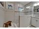 Featuring glass enclosed walk-in shower with tiled walls and shower head with wooden bath stool at 6507 Maiden Sea Dr, Apollo Beach, FL 33572
