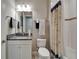 Bathroom with tiled floors, granite counters, shower and tub combination with nautical-themed shower curtain at 6507 Maiden Sea Dr, Apollo Beach, FL 33572