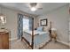 Comfortable bedroom with ceiling fan and a four-poster bed, complete with blue accents at 6507 Maiden Sea Dr, Apollo Beach, FL 33572